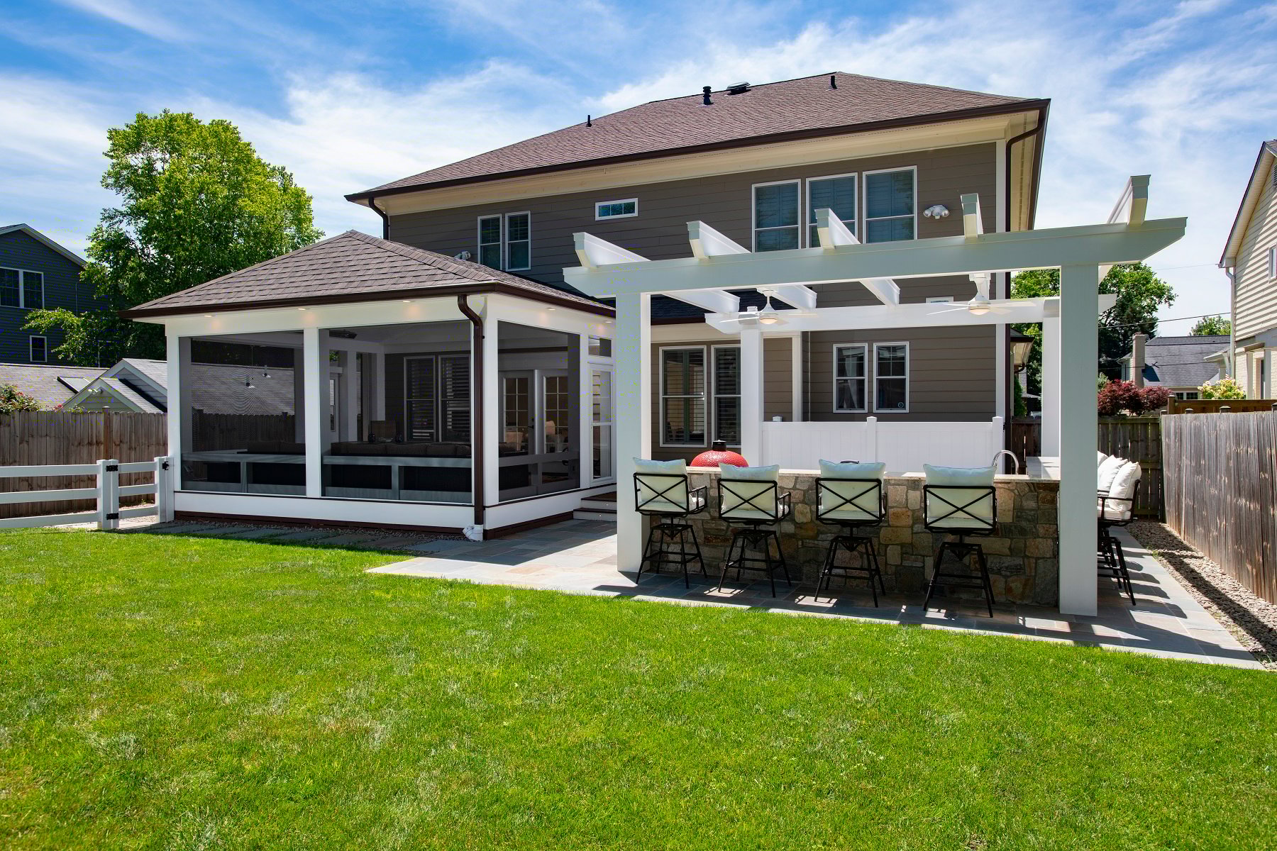 Flagstone Outdoor Kitchen Design with a Low Maintenance Screened